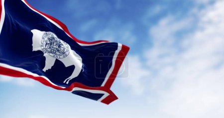 Close-up of Wyoming state flag waving in the wind. White Bison silhouette. 3d illustration render. Selective focus. US state flag