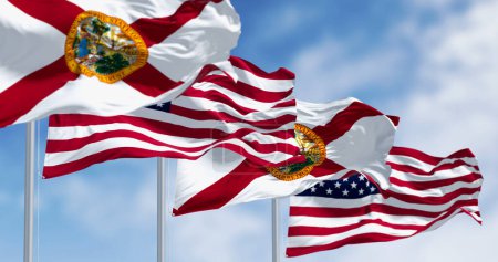 Flags of Florida and United States waving in the wind on a clear day. US state flag. Pride and patriotism concept. 3d illustration render. Fluttering textile. Selective focus