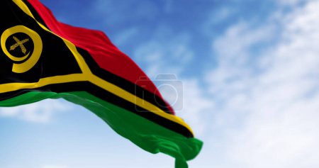 Die Nationalflagge Vanuatus weht an einem klaren Tag im Wind. Vanuatu ist ein Inselstaat im Südpazifik. 3D Illustration rendern. Selektiver Fokus.