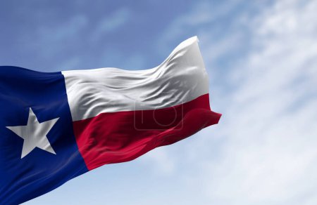 Texas state flag waving in the wind on a clear day. Blue vertical stripe with white star, white and red horizontal stripes. 3D illustration render. Close-up. Fluttering fabric