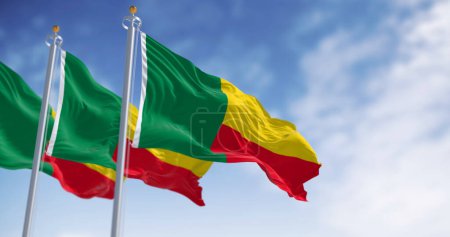 Three Benin national flags waving. Two horizontal yellow and red bands on the fly side and a green vertical band at the hoist. 3d illustration render. Fluttering fabric. Selective focus