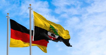 Flag of Saxony-Anhalt waving in the wind with german national flag. Saxony-Anhalt is a German state (Land). 3d illustration render. Rippling fabric.