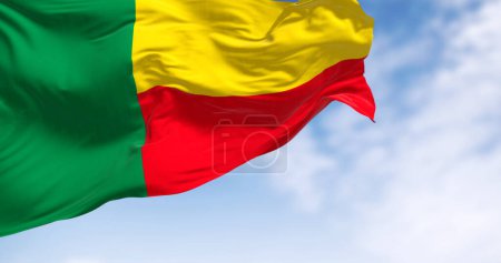 Close-up of Benin national flag waving. Two horizontal yellow and red bands on the fly side and a green vertical band at the hoist. 3d illustration render. Fluttering fabric. Selective focus
