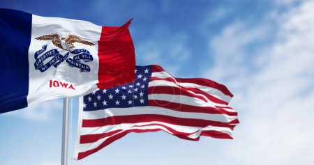 Iowa state flag waving in the wind with the American national flag on a clear day. 3d illustration render. Rippled fabric. Selective focus