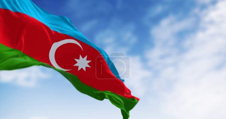 The national flag of Azerbaijan waving in the wind on a clear day. Horizontal tricolour of blue, red, green with a white crescent and star. 3D illustration render. Selective focus
