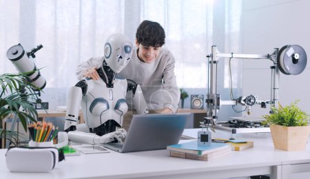 Ein Junge studiert mit Hilfe eines Roboters. Das Ergebnis ist fruchtbar. Konzept der Zusammenarbeit zwischen Robotern und Menschen.