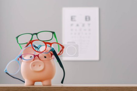 Photo for Cute piggy bank at the optician shop choosing new low-cost glasses - Royalty Free Image