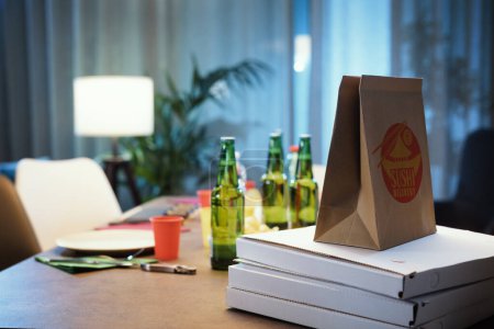 Photo for Fast food delivery at home: pizza boxes, sushi in a bag and drinks on a table - Royalty Free Image