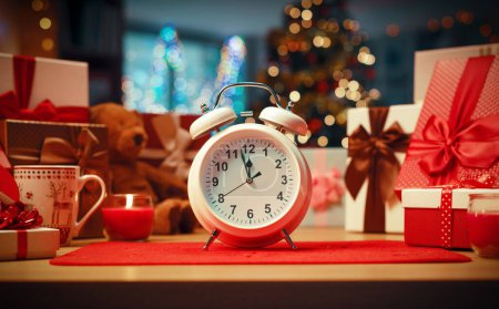 Photo for Twin bell alarm clock showing the time and home interior decorated for holidays: it's Christmas Eve - Royalty Free Image