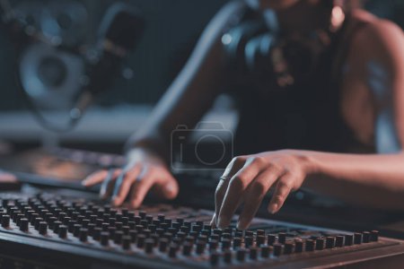 Photo for Sound engineer working in the studio, she is setting up the mixer and recording tracks, hands close up - Royalty Free Image