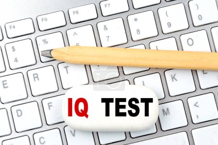 IQ TEST text on a eraser with pencil on keyboard