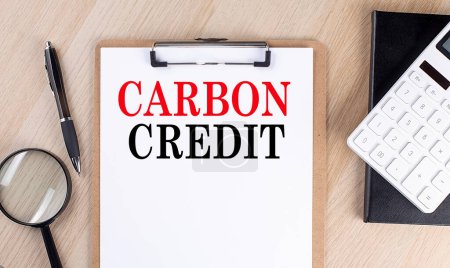 Photo for CARBON CREDIT text on clipboard on wooden background - Royalty Free Image