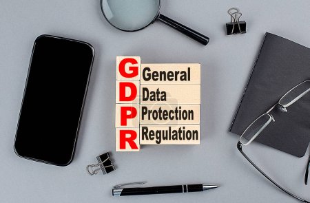 Photo for Wooden cubes GDPR wtih notebook , magnifier and smartphone, business - Royalty Free Image