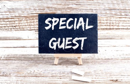 SPECIAL GUEST text on Miniature chalkboard on wooden background