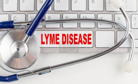 Téléchargez les photos : LYME DISEASE text on a keyboard with stethoscope , medical concept - en image libre de droit
