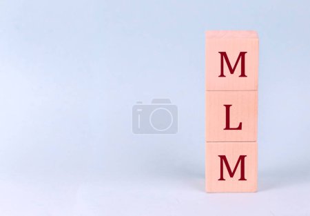 Téléchargez les photos : MLM on wooden cubes on blue background - en image libre de droit