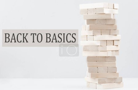 Foto de BACK TO BASICS text with wooden block stack on a white background , business concept - Imagen libre de derechos
