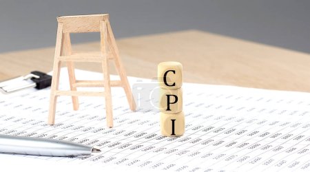 wooden cubes with the word CPI stand on financial background, business