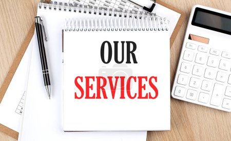 OUR SERVICES is written in white notepad near a calculator, clipboard and pen. Business