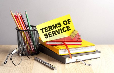 Téléchargez les photos : TERMS OF SERVICE written on sticky on notebooks - en image libre de droit