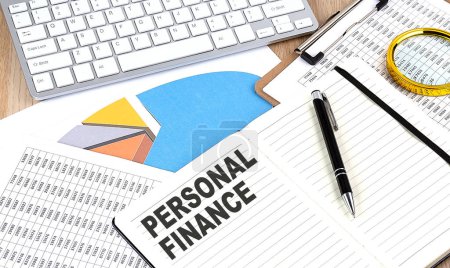 Photo for PERSONAL FINANCE text on a notebook with chart and keyboard - Royalty Free Image