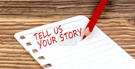 Photo for Word TELL US YOUR STORY on paper with ped pencil on wooden background - Royalty Free Image
