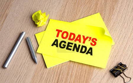 Photo for TODAY'S AGENDA written on sticky on notebooks - Royalty Free Image