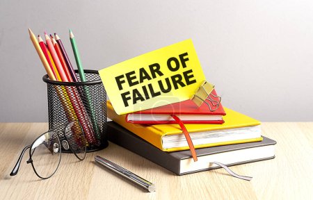 Photo for FEAR OF FAILURE written on sticky on notebooks - Royalty Free Image