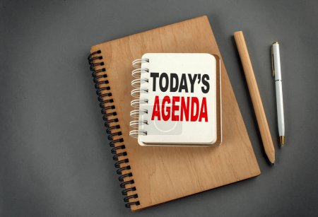 Photo for TODAY'S AGENDA text on a notebook with pen and pencil on grey background - Royalty Free Image