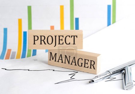 Photo for PROJECT MANAGER text on a notebook with pen and pencil on grey background - Royalty Free Image