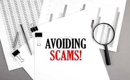 AVOIDING SCAMS text on paper on chart background