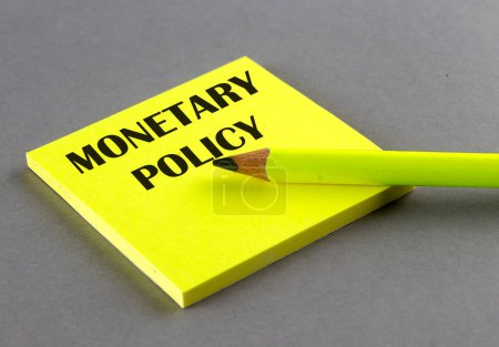 Photo for MONETARY POLICY text written on sticky on grey background - Royalty Free Image