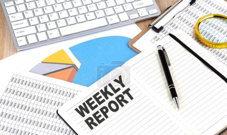 Photo for WEEKLY REPORT text on a notebook with chart and keyboard - Royalty Free Image