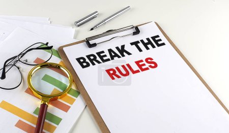 Photo for BREAK THE RULES text on a clipboard with chart on white background, business concept - Royalty Free Image