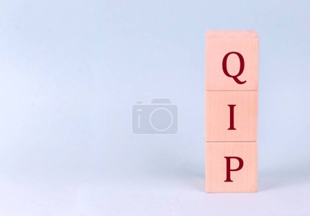 Photo for QIP on a wooden cubes on a blue background - Royalty Free Image
