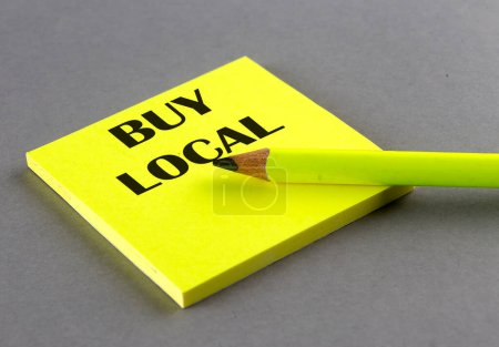 Photo for BUY LOCAL text written on sticky on grey background - Royalty Free Image