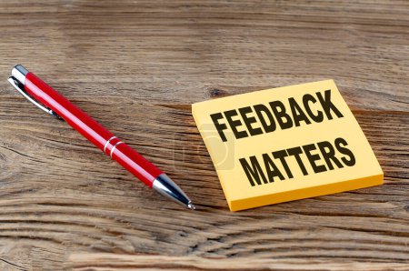 Photo for FEEDBACK MATTERS text on a sticky with pen on the wooden background - Royalty Free Image