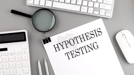 Photo for Hypothesis testing written on paper with office tools and keyboard on grey background - Royalty Free Image