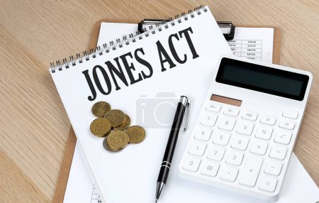 Photo for JONES ACT text with chart and calculator and coins , business - Royalty Free Image