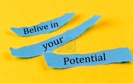 Photo for BELIEVE IN YOUR POTENTIAL text on a blue pieces of paper on a yellow background, business concept - Royalty Free Image