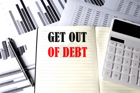 GET OUT OF DEBT text written on notebook on chart and diagram