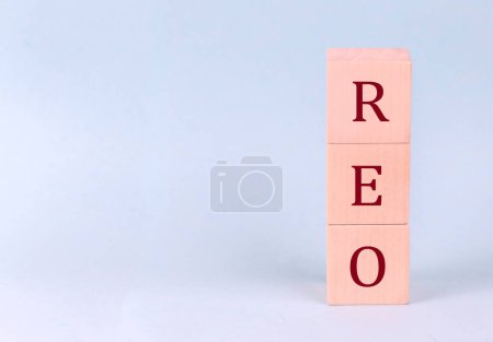 REO on a wooden cubes on a blue background
