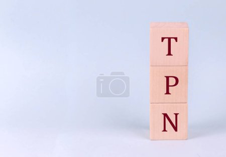 Photo for TPN - Total Parenteral Nutrition on wooden cubes on blue background - Royalty Free Image