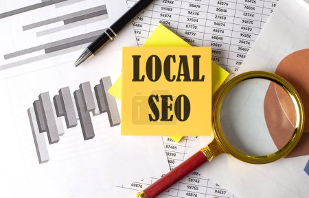 LOCAL SEO text on sticky on the graph background with pen and magnifier