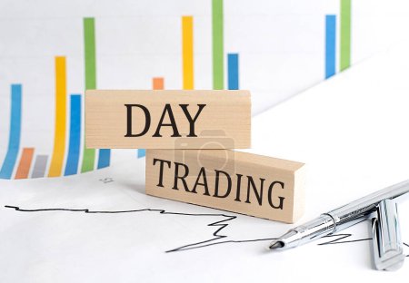 DAY TRADING text on wooden block on chart background , business concept