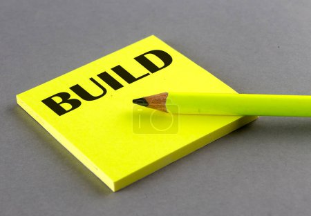 Photo for BUILD text written on sticky on grey background - Royalty Free Image