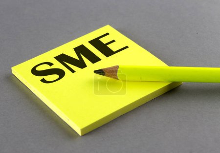 Photo for SME text written on sticky on grey background - Royalty Free Image