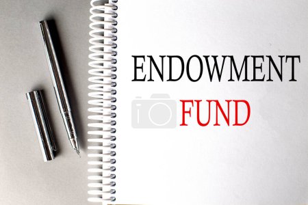 ENDOWMENT FUND text on notebook with pen on grey background