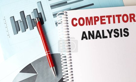 COMPETITOR ANALYSIS text on notebook with pen on a chart background
