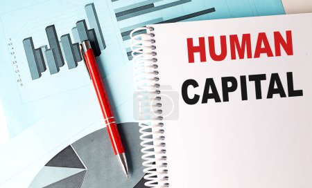 Photo for HUMAN CAPITAL text on notebook with pen on a chart background - Royalty Free Image